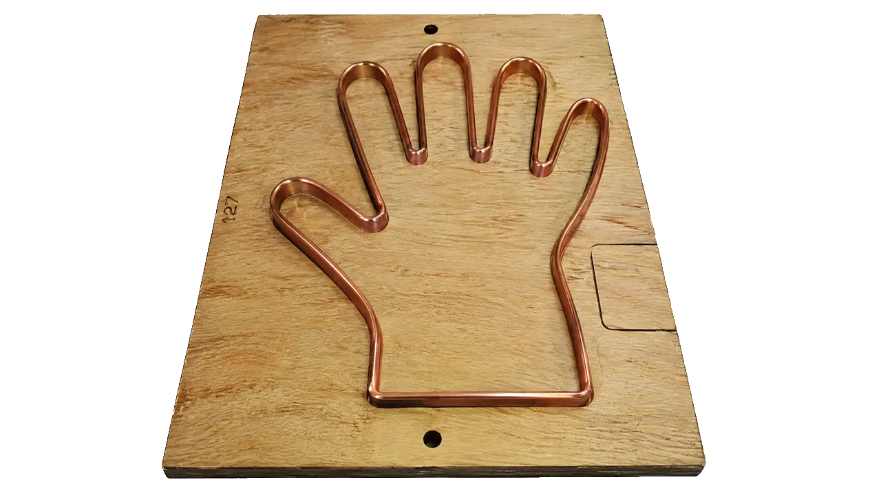 Copper glove mold close-up — LayerQuestar LQ-2LG-500 precision heat-sealing mold for PE glove bags